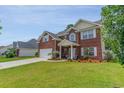 Beautiful two-story brick home featuring a manicured lawn and an attached two-car garage at 234 Sugar Mill Loop, Myrtle Beach, SC 29588