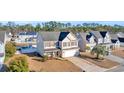Two-story house, neighborhood view, showcasing landscaping and nearby homes at 281 Sugar Mill Loop, Myrtle Beach, SC 29588