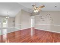 Bright living room with hardwood floors, vaulted ceiling, and a ceiling fan at 290 Georgia Mae Loop, Conway, SC 29527