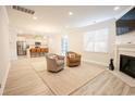 Spacious living room with hardwood floors, fireplace, and kitchen view at 3339 Moss Bridge Ln., Myrtle Beach, SC 29579