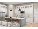 Modern kitchen with white cabinets, a large island, and stainless steel appliances at 364 Ridge Dr., Galivants Ferry, SC 29544