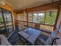 Inviting screened-in patio with a dining table, perfect for enjoying outdoor meals with a serene lake view at 410 Melrose Pl. # 219, Myrtle Beach, SC 29572