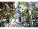 Two-story home with white siding, balconies, and a gated entrance at 429 Ocean Pointe Ct., North Myrtle Beach, SC 29582