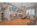 Living room with a corner fireplace, hardwood floors, and large TV at 6001-1810 S Kings Hwy., Myrtle Beach, SC 29575
