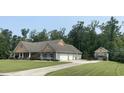 Exterior view of home with a wide driveway, multiple garage doors and an additional outbuilding at 640 Fox Hollow Rd., Murrells Inlet, SC 29576