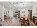 Formal dining room with a large wooden table, hardwood floors, and built-in cabinets at 816 17Th Ave. N, Surfside Beach, SC 29575