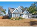 Beautiful two-story home with blue siding, solar panels, and a spacious yard at 816 17Th Ave. N, Surfside Beach, SC 29575