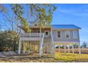 New construction home with covered porch and elevated foundation at Tbd Park St., Georgetown, SC 29440