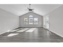 Bright living room featuring vaulted ceilings and grey flooring at 116 Brentwood Dr. # E, Murrells Inlet, SC 29576