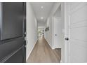 Bright hallway with light hardwood floors and neutral walls at 152 Carolina Lakes Blvd., Myrtle Beach, SC 29588