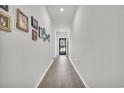 Long hallway with hardwood floors and framed pictures on the wall at 152 Carolina Lakes Blvd., Myrtle Beach, SC 29588