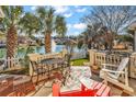 Relaxing patio with lake view, fountain, and seating area at 238 Cold Water Circle, Myrtle Beach, SC 29588