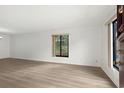 Empty living room with light brown laminate floors and large window at 309 74Th Ave. N # 18, Myrtle Beach, SC 29572