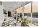 Bright screened porch with white walls, ceiling fans, and view of parking lot at 309 74Th Ave. N # 18, Myrtle Beach, SC 29572