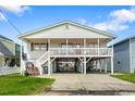 Charming beach house featuring an elevated design and a large deck at 327 55Th Ave. N, North Myrtle Beach, SC 29582