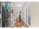Inviting entryway featuring hardwood floors, a console table with decor, and French doors at 3716 Mackevans Ct., Myrtle Beach, SC 29579