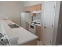 Simple kitchen with light wood cabinets and white appliances at 448 Red River Ct. # 39H, Myrtle Beach, SC 29579