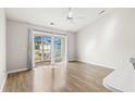 Living room with wood flooring and sliding glass doors to a balcony at 448 Red River Ct. # 39H, Myrtle Beach, SC 29579