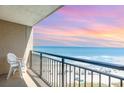 Balcony view of the beach and ocean with sunset colors at 4800 S Ocean Blvd. # 1007, North Myrtle Beach, SC 29582