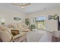 Spacious living room with light beige couches and access to a balcony at 4855 Luster Leaf Circle # 302, Myrtle Beach, SC 29577