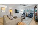 Bright living room with light beige sofa and blue armchairs at 838 Sandy Side Dr., Little River, SC 29566