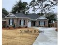 Similar house with brick facade, landscaping, and driveway at 93 Pintail Ct., Pawleys Island, SC 29585