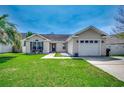 Charming one-story home featuring a well-manicured lawn, neutral siding, and attached garage at 9650 Bradford Ln., Murrells Inlet, SC 29576