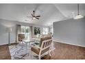 Bright living room with vaulted ceilings, wood floors, stylish furniture, and sliding glass door at 9650 Bradford Ln., Murrells Inlet, SC 29576