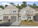 Tan siding two-story townhome with two-car garage and landscaping at 100 Machrie Loop # 17-C, Myrtle Beach, SC 29588