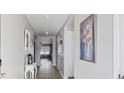 Long hallway leading to living areas with hardwood floors at 124 Golden Bear Circle, Longs, SC 29568