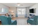 Living room with teal armchairs and brown sofa at 124 Golden Bear Circle, Longs, SC 29568