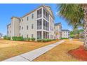 Well-maintained condo complex with a paved walkway and manicured shrubs and landscaping at 2080 Cross Gate Blvd. # 303, Surfside Beach, SC 29575