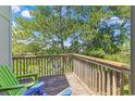 Wooden deck with wooden railings and chairs overlooking the water at 25 Frigate Ct., Pawleys Island, SC 29585