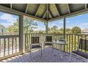 Spacious screened porch with seating area and water views at 25 Frigate Ct., Pawleys Island, SC 29585