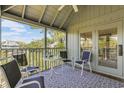 Relaxing screened porch with seating area and water views at 25 Frigate Ct., Pawleys Island, SC 29585