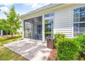 Screened porch with patio furniture overlooking backyard at 257 Connemara Dr. # E, Myrtle Beach, SC 29579
