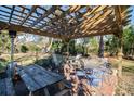 Wooden pergola with picnic table and chairs in backyard at 301 North Main St., Hemingway, SC 29554