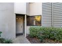 Exterior entryway with a light gray door and well-maintained shrubs at 305 Myrtlewood Ct. # 18C, Myrtle Beach, SC 29572