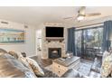 Living room with fireplace, TV, and sliding glass doors leading to a balcony at 305 Myrtlewood Ct. # 18C, Myrtle Beach, SC 29572