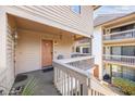 Welcoming front porch with seating, a door, and a view of adjacent units, perfect for relaxing outdoors at 306 74Th Ave. N # 208, Myrtle Beach, SC 29572