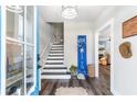 Bright entryway with stairs leading upstairs, and a view into the living room at 34 Lazy Hammock Trail, Pawleys Island, SC 29585