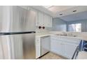 Stainless steel appliances and white cabinets in a galley-style kitchen at 38 Shadow Moss Pl. # 38, North Myrtle Beach, SC 29582