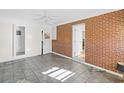 Sunroom with brick wall, tile floor, and access to patio at 408 S 16Th Ave. S, Myrtle Beach, SC 29577