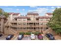 Multi-level condo building with ample parking, showcasing convenient access and a welcoming facade with multiple decks at 501 Maison Dr. # F12, Myrtle Beach, SC 29572