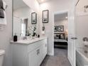 Modern bathroom featuring double vanity, tiled floors, and access to an adjacent bedroom and shower at 5028 Riverton Ct, Myrtle Beach, SC 29579