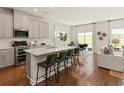 Modern kitchen with gray cabinets, island, stainless steel appliances, and hardwood floors at 5032 Riverton Ct, Myrtle Beach, SC 29579