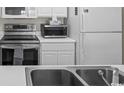 Stainless steel sink and stove top in kitchen at 5060 Windsor Green Way # 203, Myrtle Beach, SC 29579