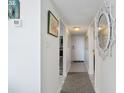 White hallway with tile floors and artwork, connecting rooms at 601 Mitchell Dr. # 1002, Myrtle Beach, SC 29577