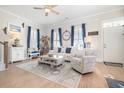 Living room with light-colored furniture, coastal decor, and hardwood floors at 839 Rosa Circle, Myrtle Beach, SC 29577