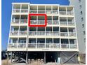 Condo balcony with partial ocean view, featuring a small table and chairs at 1000 N Waccamaw Dr. # 302, Murrells Inlet, SC 29576
